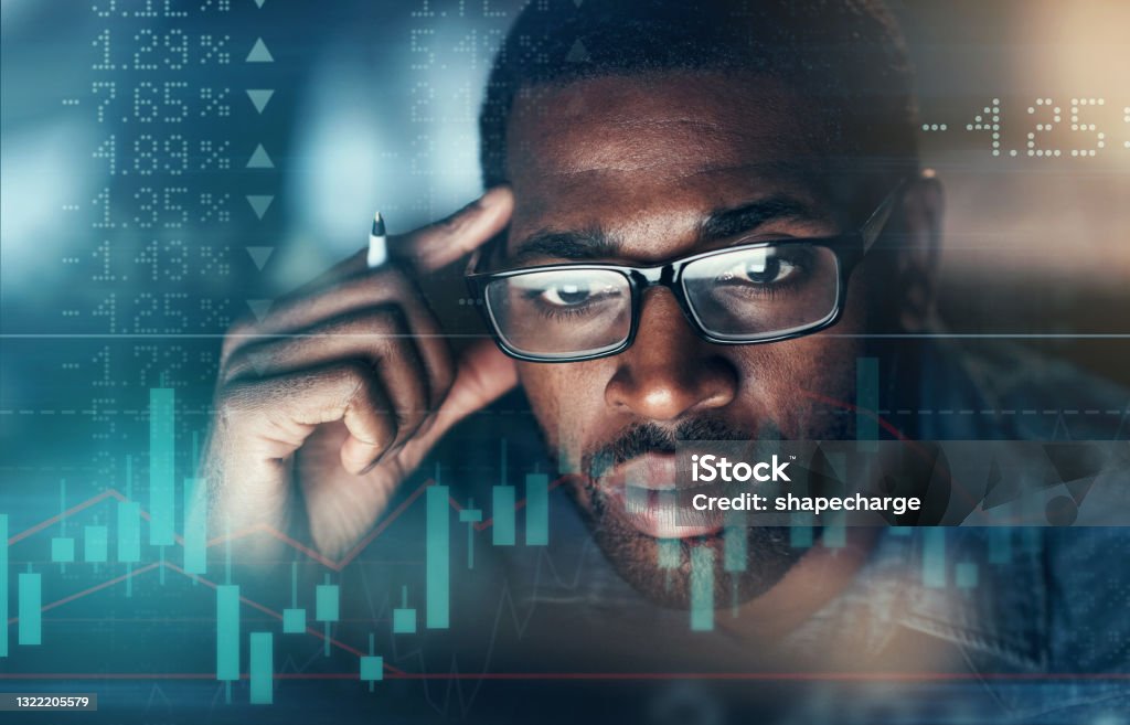 Digitally enhanced shot of an unrecognizable businessman working in the office superimposed over a graph showing the ups and downs of the stock market Laser like focus leads you to the answer Stock Market and Exchange Stock Photo