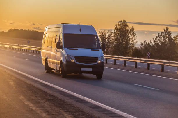 istock minibus moves along suburban highway 1322206320