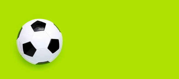 istock Soccer ball on green background. Top view 1322206614