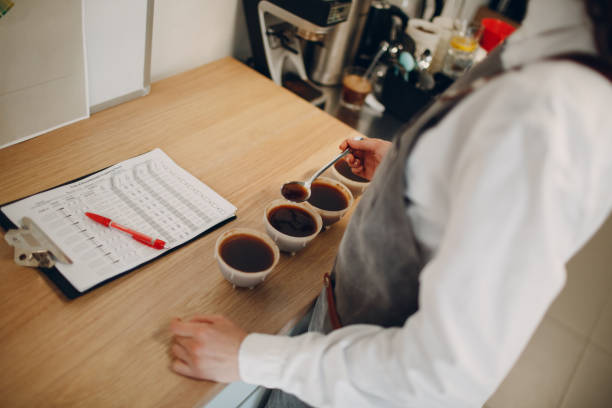 istock Cup Taster Girl Tasting Degustation Coffee Quality Test. Coffee Samples Cupping 1322210468