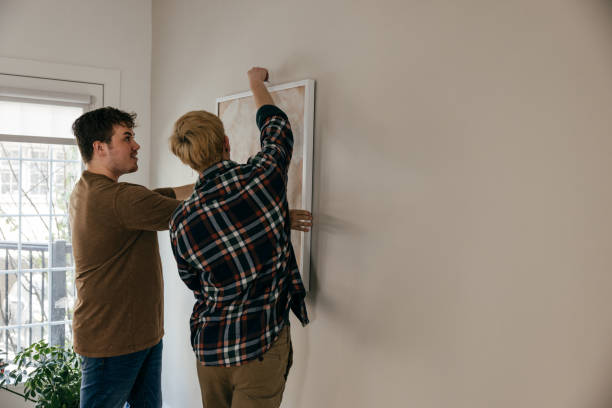 istock LGBT couple decorating their apartment 1322211470