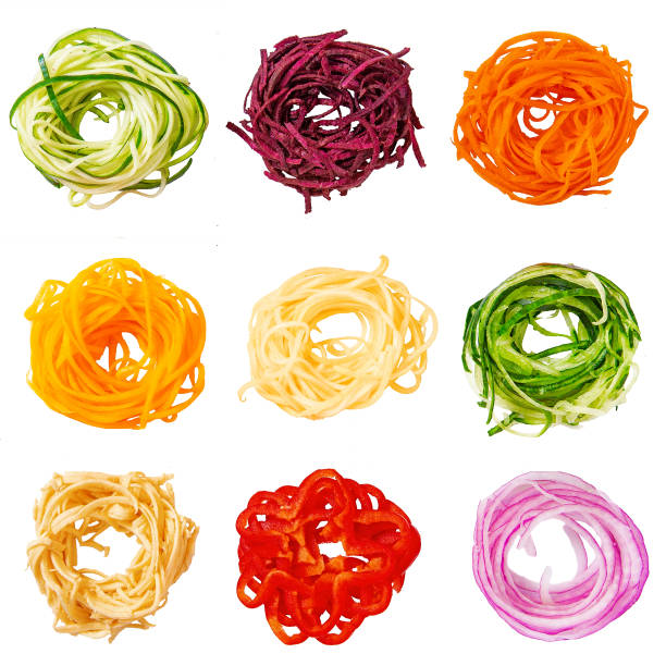 spiralized nests of zucchini, beets, pumpkin, squash, sweet potatoes, cucumber, vegetable banana, red pepper, red onion. isolated on white background.