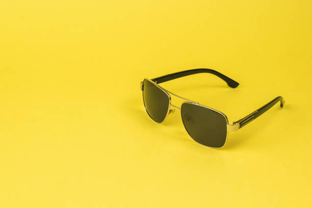 istock Stylish sunglasses for men on a yellow background. 1322223853