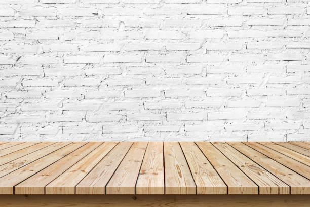 istock empty wooden table top on white brick wall background, used for display or montage your products 1322229554