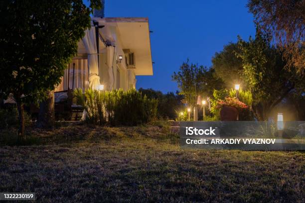 Yard And Bungalow Lit By Lanterns Night On The Sea Coast Stock Photo - Download Image Now