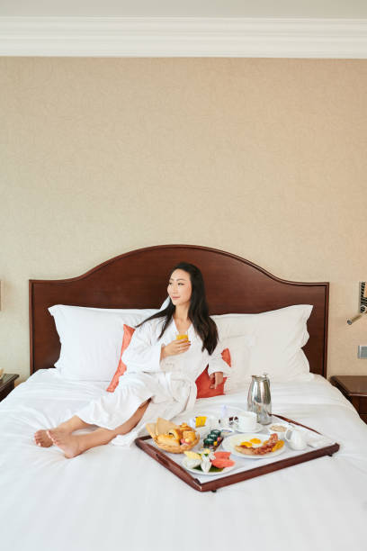 istock Woman eating breakfast in bed 1322233368