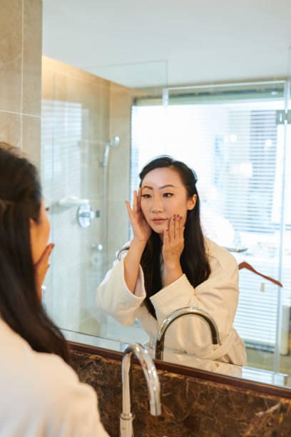 istock Young woman applying skincare 1322233371