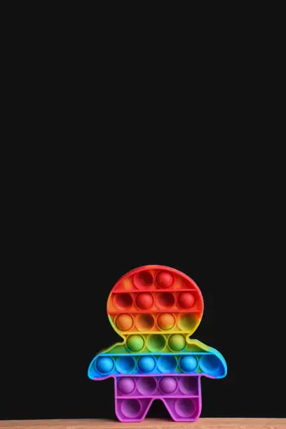 Photo of rainbow toy pop it on a black background. mock up