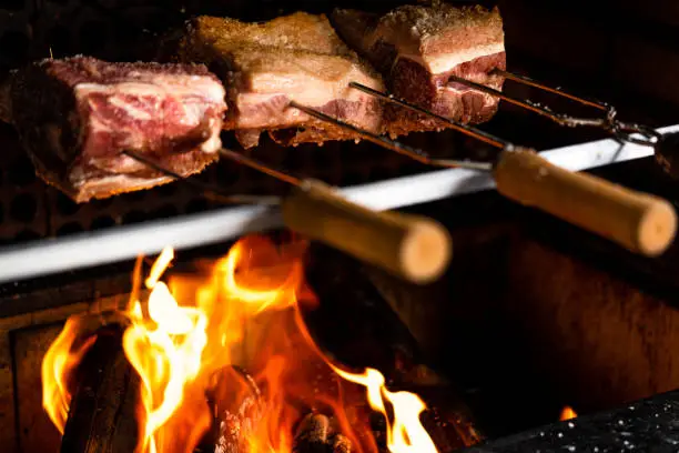 Traditional Brazilian barbecue grilled with rock salt. Red-hot fire.