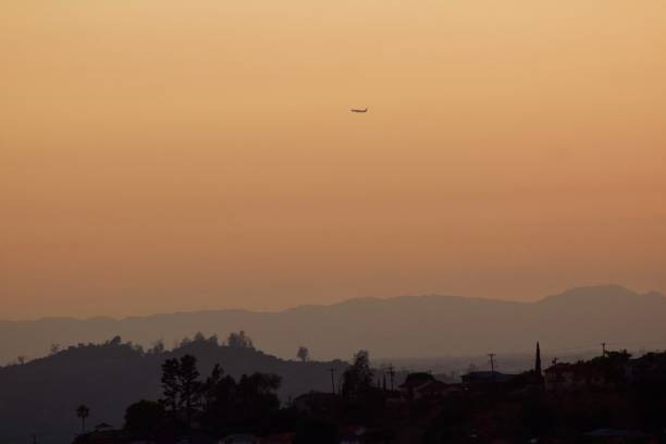 Plane in Los Angeles Sunset Plane over sunset hills eagle rock stock pictures, royalty-free photos & images