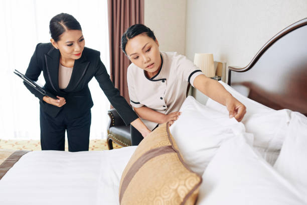 istock Hotel Manager Teaching New Maid 1322239132