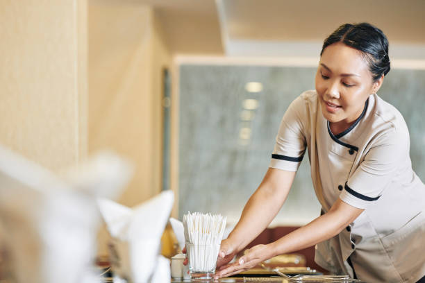 Waitress Putting Napkins On Table