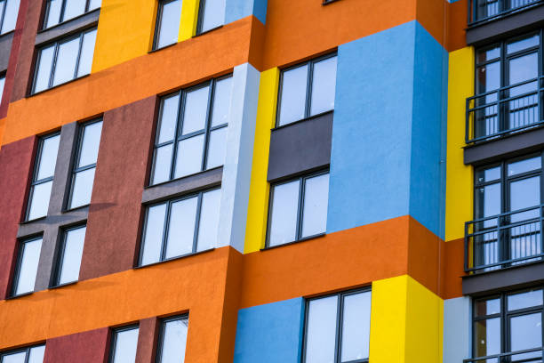 istock Modern building angle and windows. Multistory new multicolored apartment building. Stylish living block of flats. Bright juicy colors in the construction of buildings 1322241121