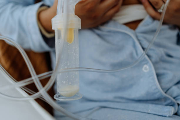 istock Mother using device at home to extract human milk for her baby 1322241261