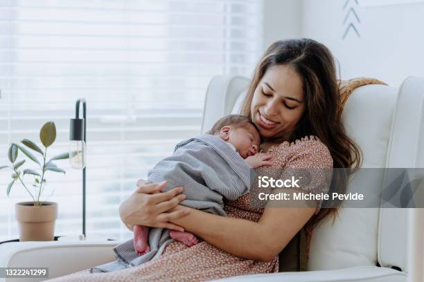 Mother Holding Her Baby Boy In The Nursery Room Stock Photo - Download Image Now - Newborn, Mother, Baby - Human Age