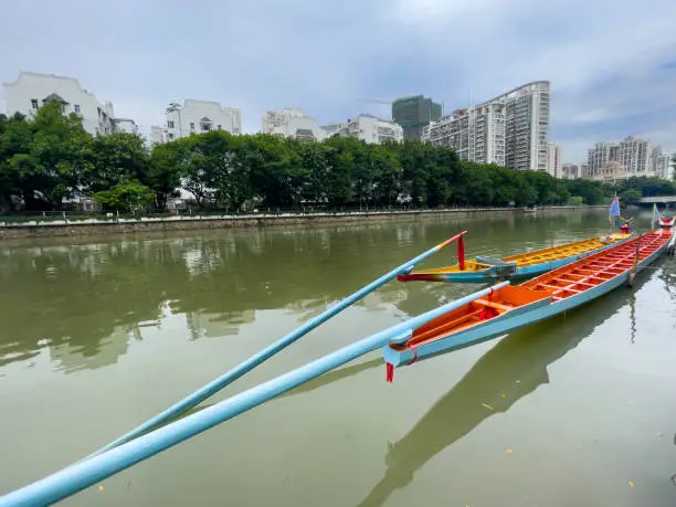 Fuzhou,Fujian,China, - June 7,2021 : Two empty Dragon boat just launched prepare to race in  the Dragon-boat Festival, 5th of the fifth lunar month in China. Viewed from the stern with long oars.