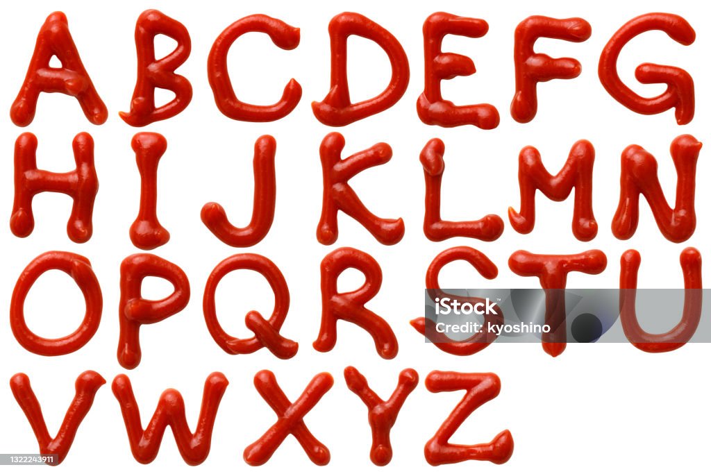 Isolated shot of upper case letters alphabetical order written in ketchup on white background Overhead shot of upper case letters alphabetical order written in ketchup on white background. Ketchup Stock Photo