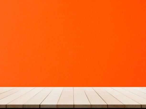 istock Wooden table perspective with wall red or orange board display show room interiors 1322246576