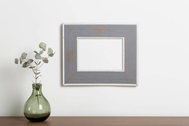 istock Mock up empty frame background. Empty decorative frame for a photo or painting in a light Scandinavian minimalist interior on a white clean wall. 1322246772