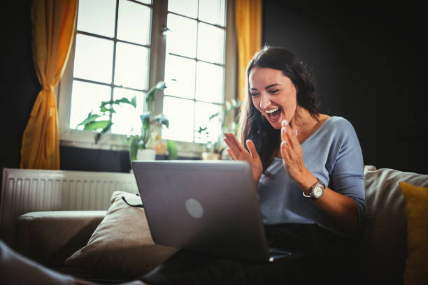 istock Smiling young  woman using mobile phone app playing game, shopping online, ordering delivery 1322246925