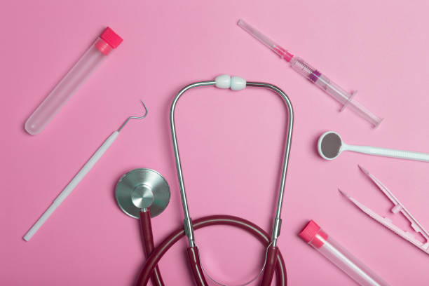 medical instruments, devices and items on the colored table in the hospital. syringe, test tube, tweezers. healthcare, medicine, treatment and doctors concept - nurse hygiene emotional stress surgeon imagens e fotografias de stock