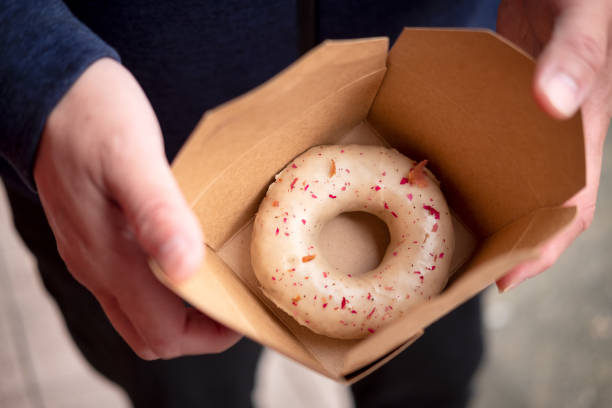 istock Vegan Gourmet Donut with Rose Petals in Cardboard Container 1322247556