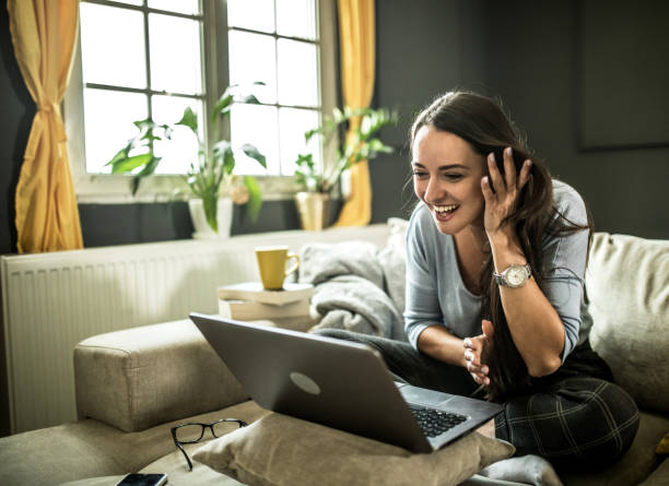 istock Smiling young  woman using mobile phone app playing game, shopping online, ordering delivery 1322247944