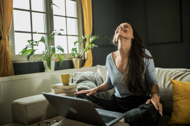 istock Smiling young  woman using mobile phone app playing game, shopping online, ordering delivery 1322247977