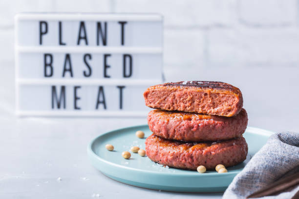 Burgers made from plant based meat, food reducing carbon footprint Burgers made from plant based meat on a table. Food to reduce carbon footprint, sustainable consumption meat stock pictures, royalty-free photos & images