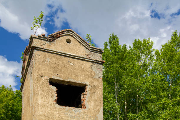 istock Ancient dilapidated tower in a modern city park. 1322250592