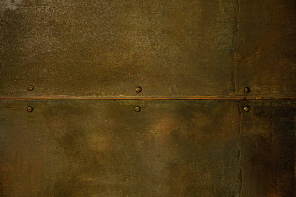 istock Old metal rusty blank background plate with seam and rivets close up 1322255848