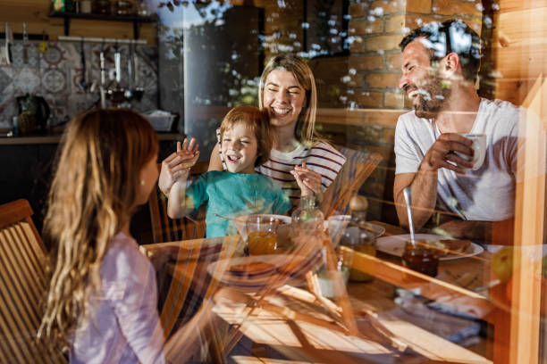 istock Happy family having fun during their breakfast at dining table. 1322256381