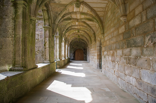 Gothic monastery corridor adjacent to the courtyard garden. Ruta da pedra e da auga, Galicia