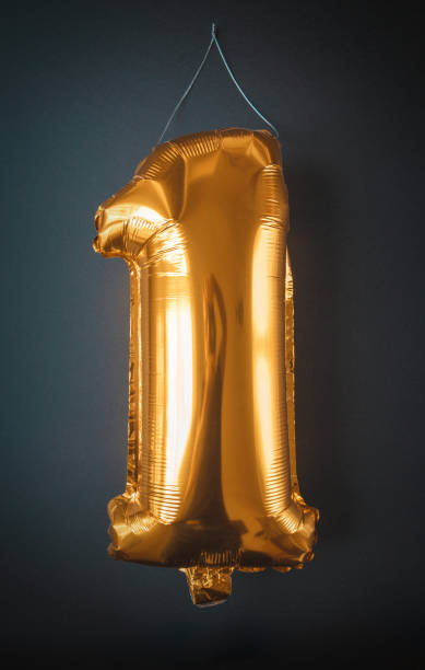 istock Gold foil Balloon number one isolated on black 1322258365