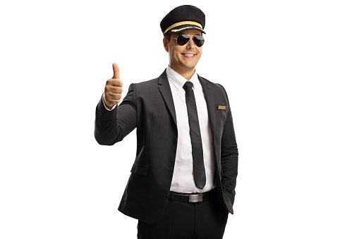 Pilot in a uniform and sunglasses smiling at camera and showing thumbs up isolated on white background