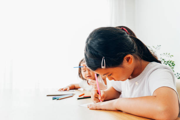 istock Children studying with their mothers 1322259297