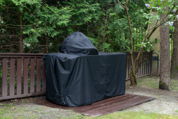 Photo of Barbecue grill Cover protecting kamado-style ceramic grill from rain.