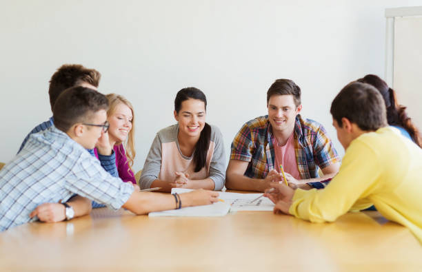 istock group of smiling students with blueprint 1322260017