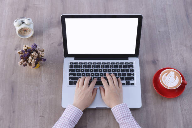 istock Top view, Close-up hands using laptop working on wooden table with a cup of coffee and accessories. 1322262152