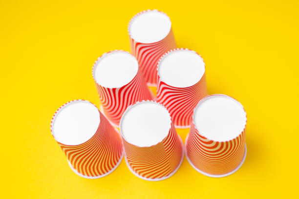 Pyramid of red paper cups on green background. minimalism concept Stock  Photo - Alamy
