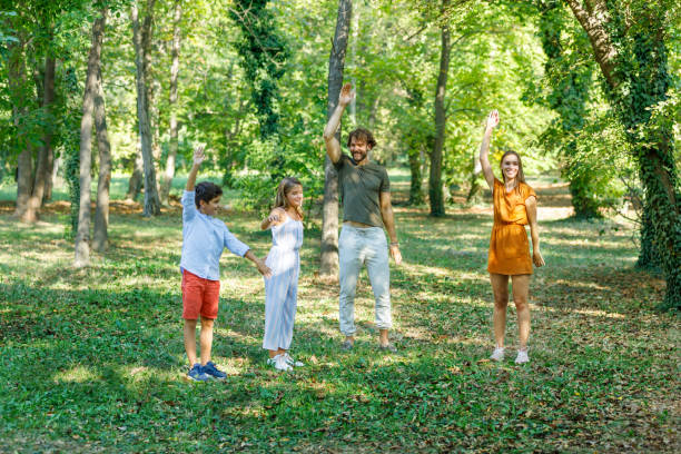 istock A Happy Family is Having a Workout in a Meadow Field. 1322264970