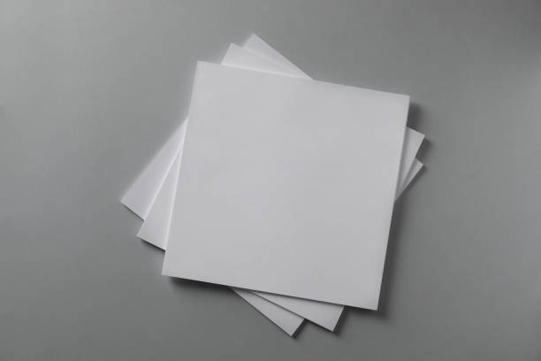 istock Stack of blank paper sheets for brochure on light grey background, top view 1322265816