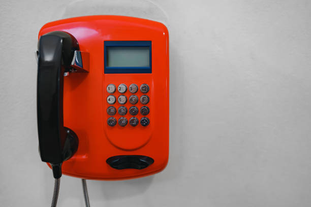 Telephone receiver hanging in telephone booth