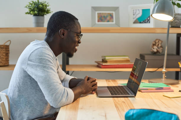 istock Man talking online at home 1322268905