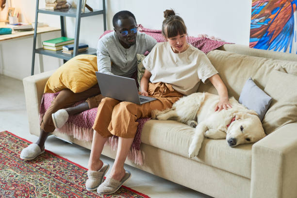 istock Couple with dog sitting at home 1322268972