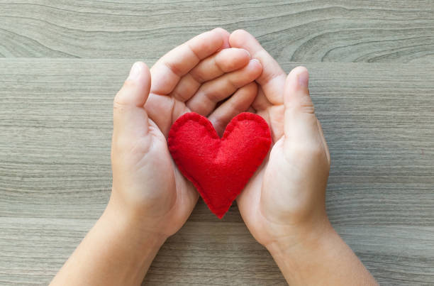 istock Hands holding a red heart out of felt. 1322269341