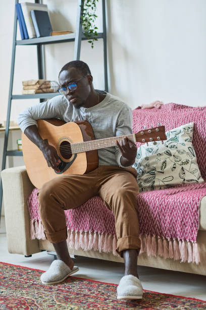 istock African man playing guitar 1322269454