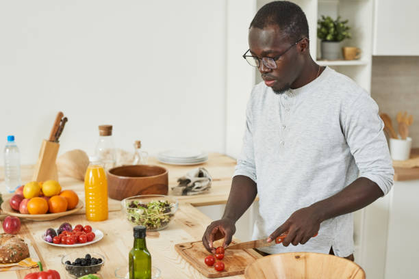 istock Man cutting vegetables for salad 1322270269