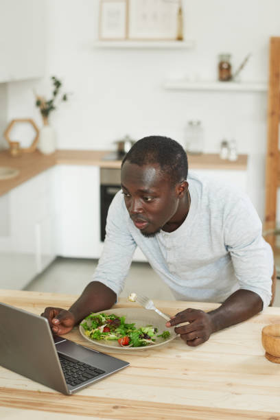 istock Man working on laptop in the kitchen 1322270309