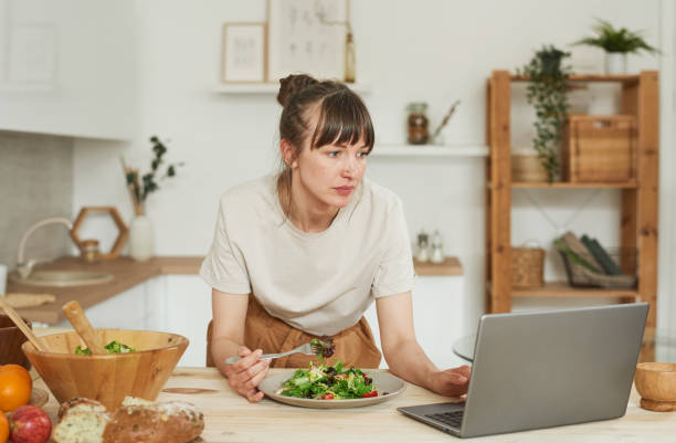 istock Woman using laptop during lunch 1322270313